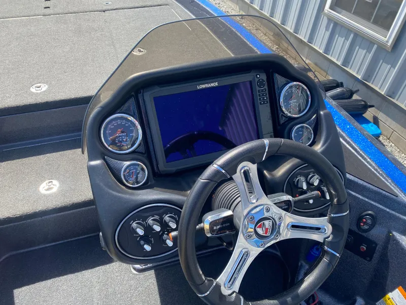 Slide: The Image of Dashboard of a 2019 Triton 20 TRX Patriot boat with steering wheel and digital display. - 10