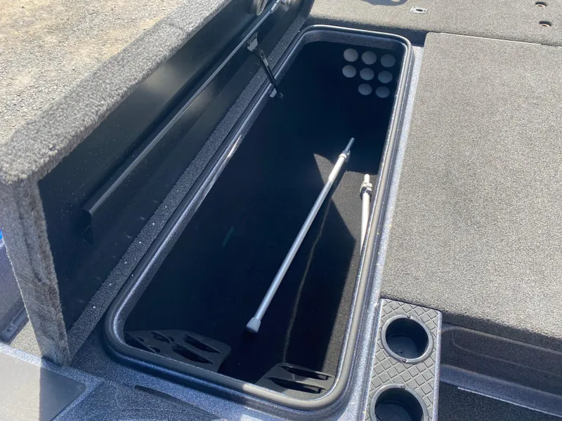 Slide: The Image of 2019 Triton 20 TRX Patriot boat storage compartment with rod holders and cup holders. - 18