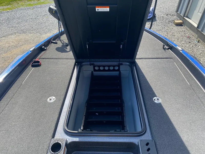 Slide: The Image of 2019 Triton 20 TRX Patriot boat storage compartment open, showing interior details. - 19