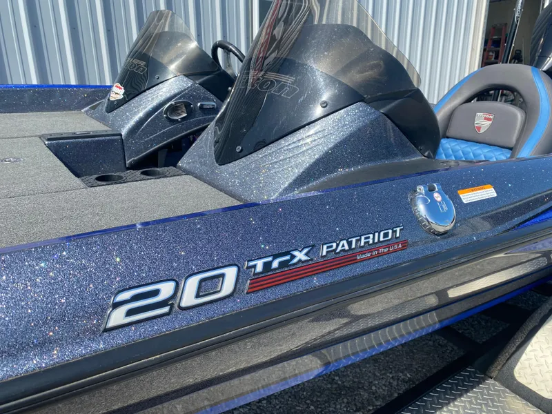 Slide: The Image of 2019 Triton 20 TRX Patriot boat with sleek design and dual consoles. - 7