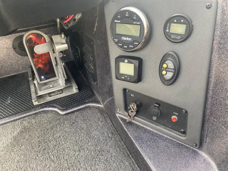 Slide: The Image of Control panel of a 2020 Triton 21 TrX boat with various gauges and switches. - 12