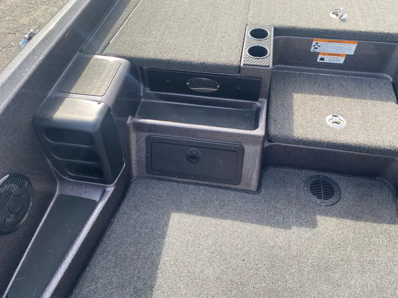 Slide: The Image of 2020 Triton 21 TrX boat interior with storage compartments and cup holders. - 13