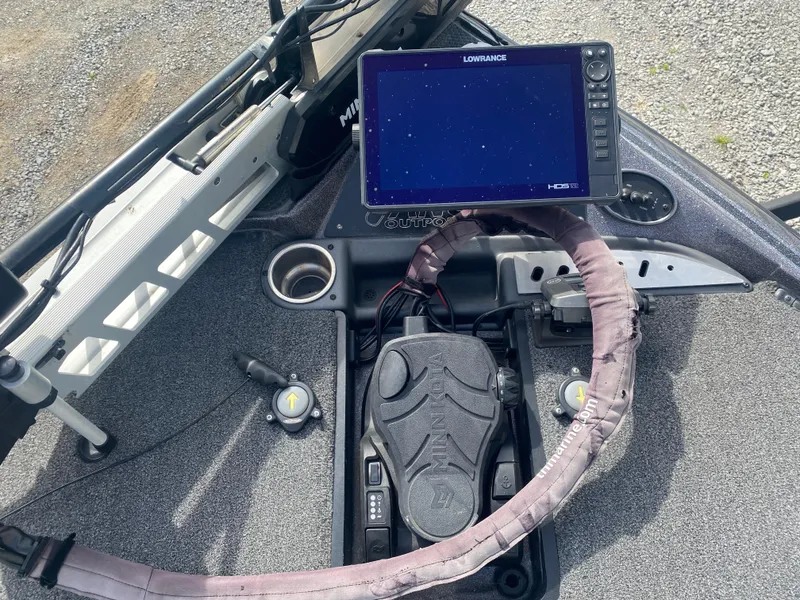Slide: The Image of 2020 Triton 21 TrX boat dashboard with Lowrance fishfinder and steering wheel. - 15