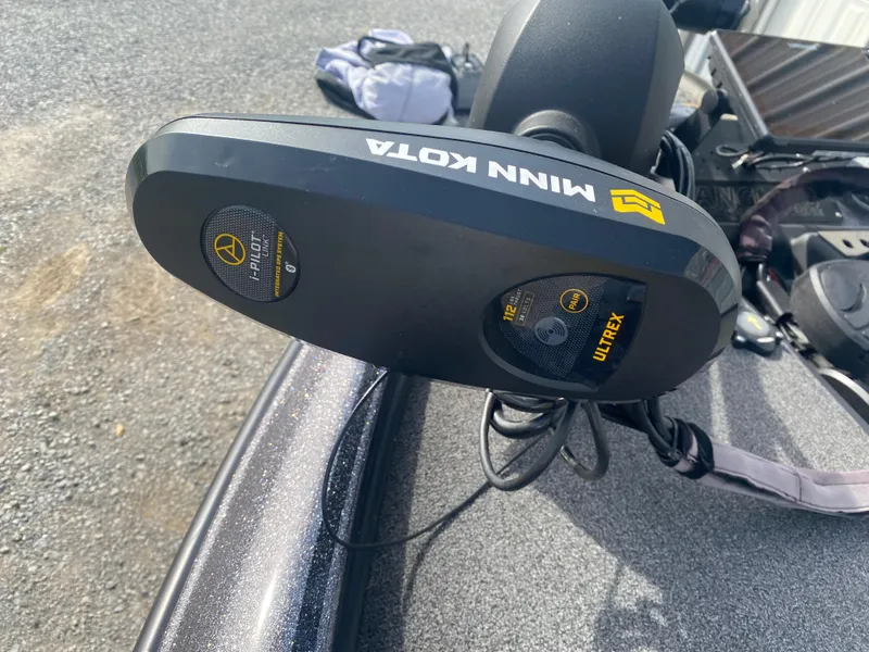 Slide: The Image of Minn Kota Ultrex motor on 2020 Triton 21 TrX boat, parked on gravel. - 16