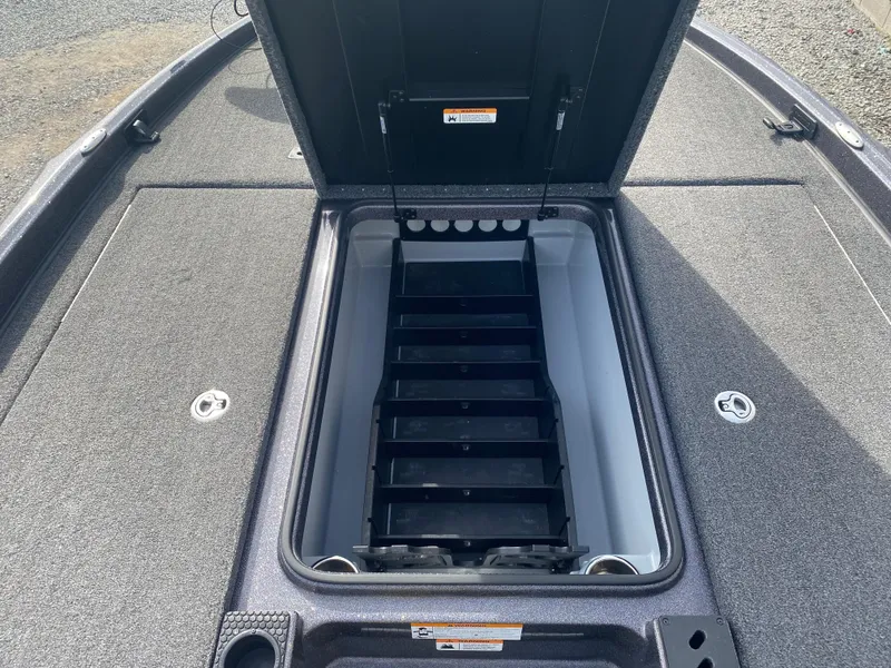 Slide: The Image of Open storage compartment on a 2020 Triton 21 TrX boat deck. - 19