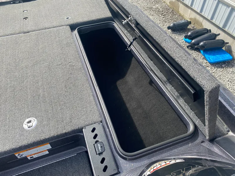 Slide: The Image of Open storage compartment on a 2020 Triton 21 TrX boat deck. - 20
