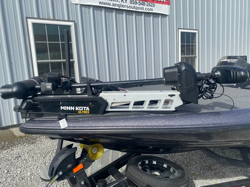 Slide: The Image of 2020 Triton 21 TrX boat with Minn Kota Ultrex trolling motor, parked outside a building. - 5