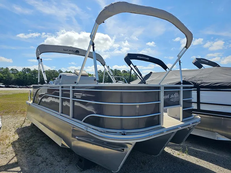 Slide: The Image of 2023 SunCatcher Select 320 F pontoon boat with canopy, parked outdoors under blue sky. - 1