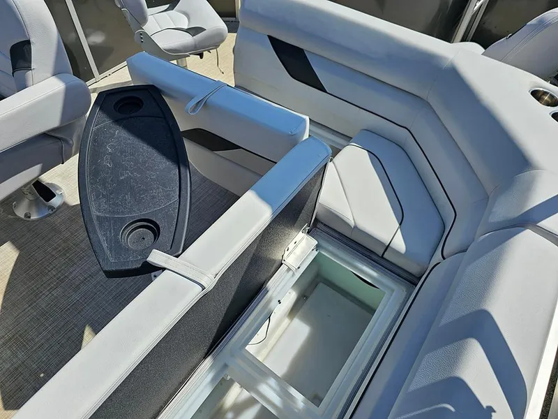 Slide: The Image of 2023 SunCatcher Select 320 F boat interior with seating and storage compartment. - 12