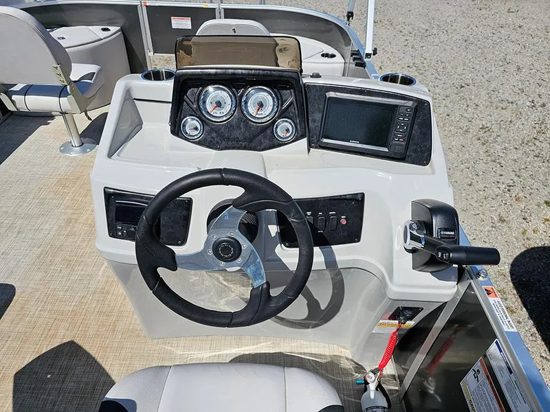Slide: The Image of 2023 SunCatcher Select 320 F boat dashboard with steering wheel, gauges, and controls. - 15