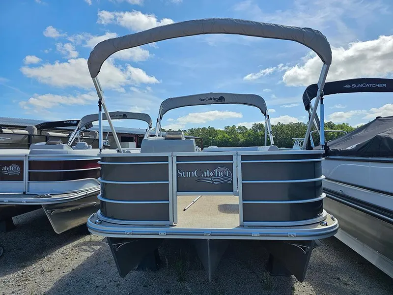 Slide: The Image of 2023 SunCatcher Select 320 F pontoon boat with canopy, parked outdoors under blue sky. - 2