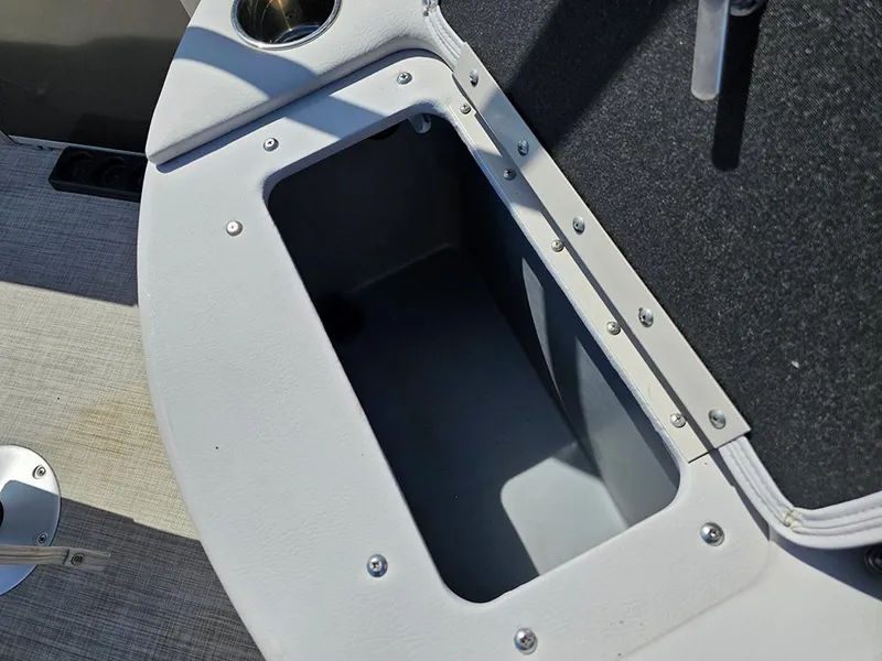 Slide: The Image of 2023 SunCatcher Select 320 F boat storage compartment with cup holder and secure lid. - 20