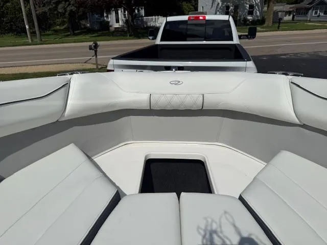 Slide: The Image of 2025 Regal LS2 boat interior with white seating, parked in front of a pickup truck. - 14