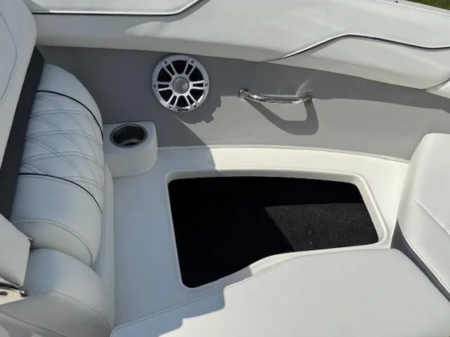 Slide: The Image of Interior of 2025 Regal LS2 boat with white seating and speaker. - 16