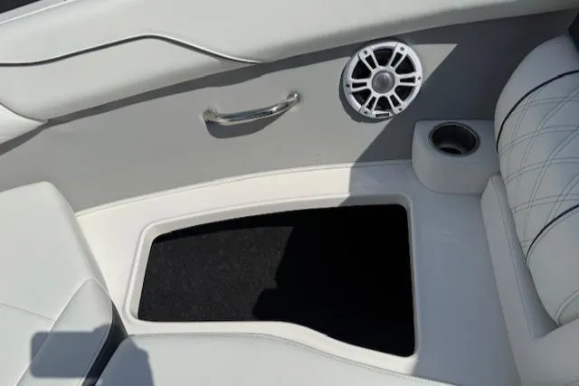 Slide: The Image of Interior of 2025 Regal LS2 boat with speaker, handle, and storage compartment. - 17