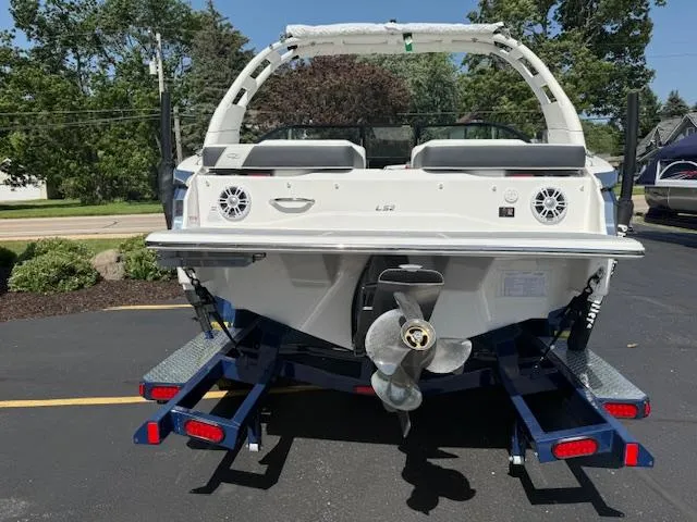 Slide: The Image of 2025 Regal LS2 boat on trailer, rear view showing propeller and speakers. - 2