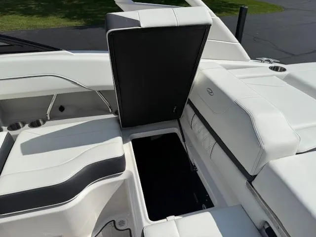 Slide: The Image of 2025 Regal LS2 boat interior with white seating and storage compartment open. - 28