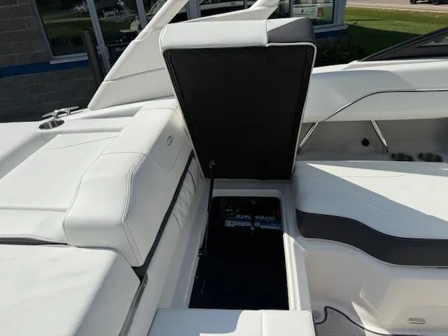 Slide: The Image of 2025 Regal LS2 boat interior with open storage compartment, featuring sleek white seating. - 29