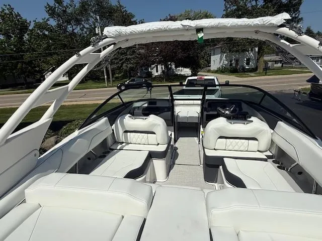 Slide: The Image of 2025 Regal LS2 boat with white interior and sleek design, parked outdoors. - 5