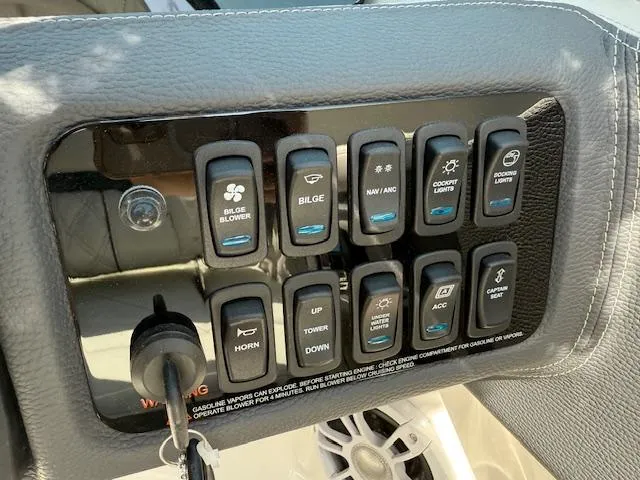 Slide: The Image of Control panel of a 2025 Regal LS2 boat with labeled switches and key ignition. - 8