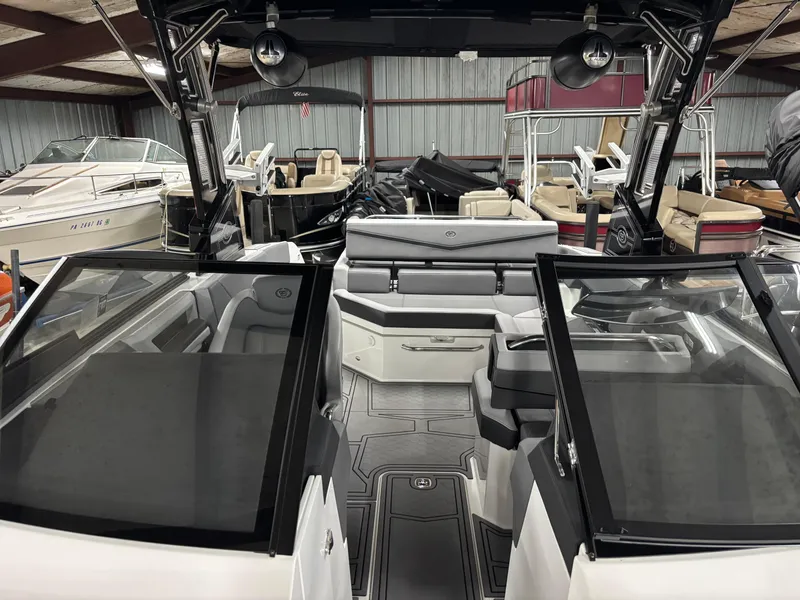 Slide: The Image of 2023 Cobalt R4 Surf boat interior in showroom, featuring sleek design and modern seating. - 12
