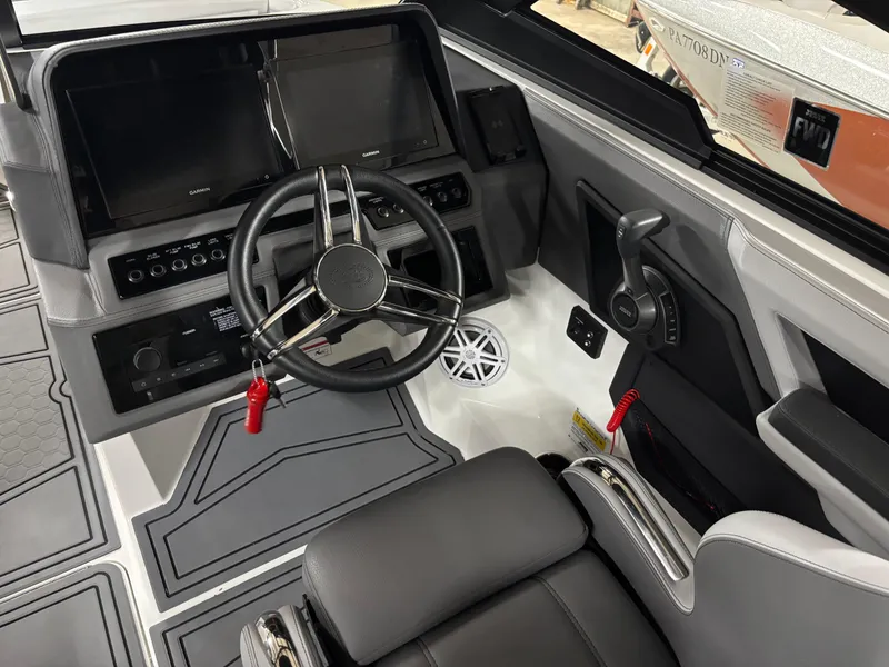 Slide: The Image of 2023 Cobalt R4 Surf boat cockpit with modern steering and controls. - 16