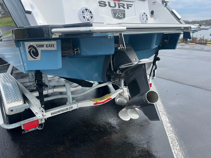 Slide: The Image of 2023 Cobalt R4 Surf boat on trailer, featuring Surf Gate technology. - 4