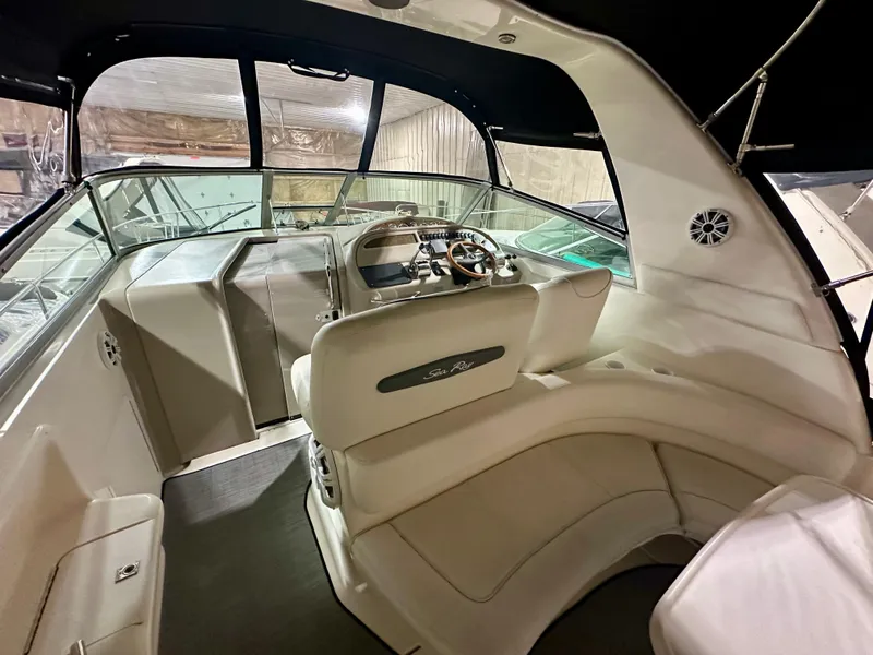 Slide: The Image of 1999 Sea Ray 310 Sundancer boat interior with helm and seating area. - 11
