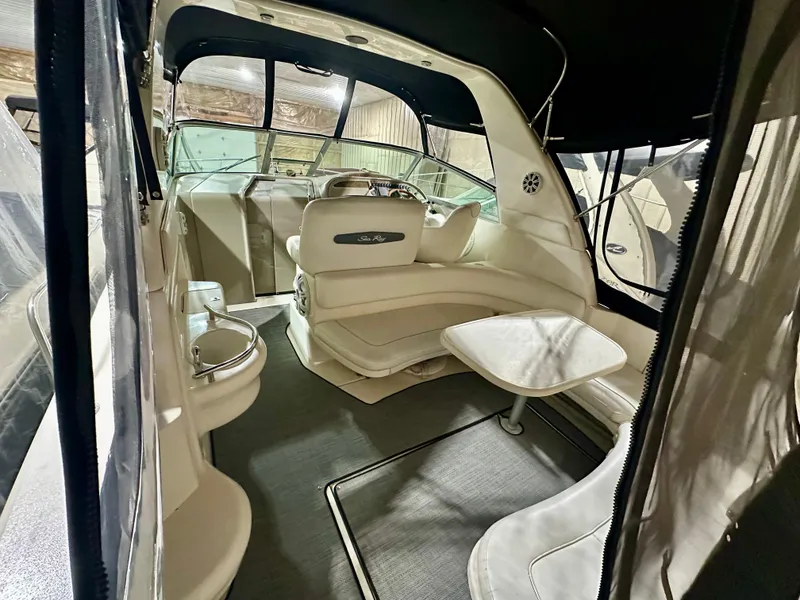 Slide: The Image of 1999 Sea Ray 310 Sundancer interior with seating and table, showcasing luxury boat design. - 9