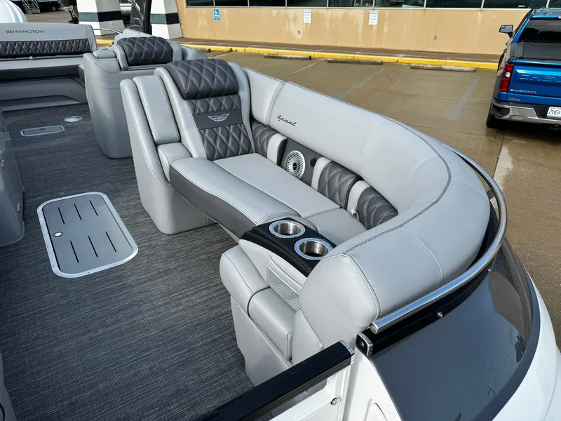 Slide: The Image of 2024 Bennington 25 QXSBA pontoon boat with luxurious gray seating and cup holders. - 12