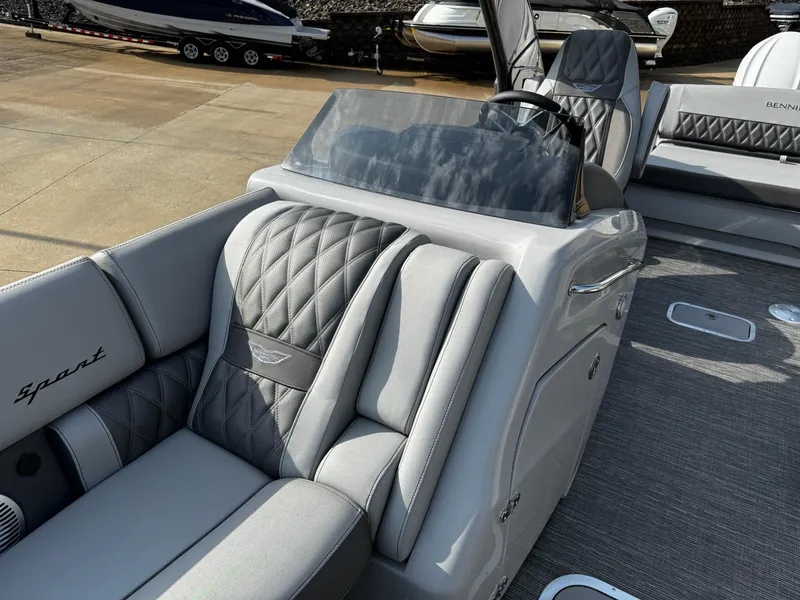 Slide: The Image of 2024 Bennington 25 QXSBA boat with luxurious gray seating and sleek dashboard design. - 15