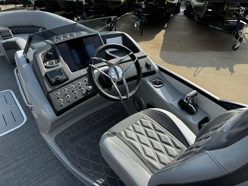 Slide: The Image of 2024 Bennington 25 QXSBA boat cockpit with modern steering and control panel. - 18
