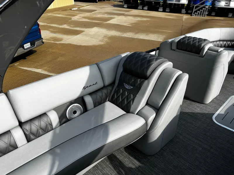 Slide: The Image of 2024 Bennington 25 QXSBA boat interior with luxurious gray seating and speaker system. - 19