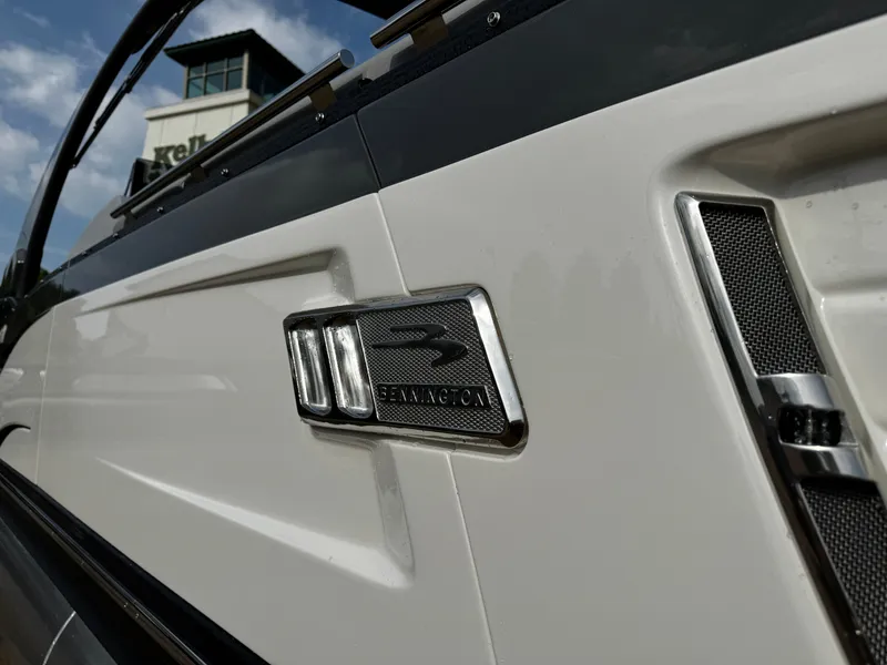 Slide: The Image of 2024 Bennington 25 QXSBA boat detail with logo and sleek design. - 2