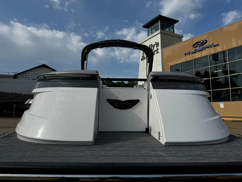 Slide: The Image of 2024 Bennington 25 QXSBA boat at a dealership, showcasing sleek design and modern features. - 4