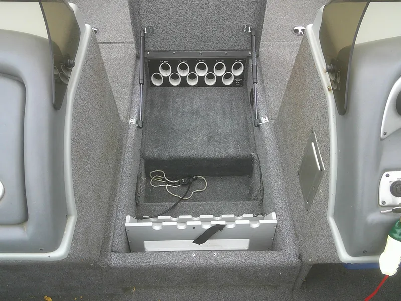 Slide: The Image of Interior of a 2007 Lund 1900 Pro-V SE boat showing storage compartments and rod holders. - 18