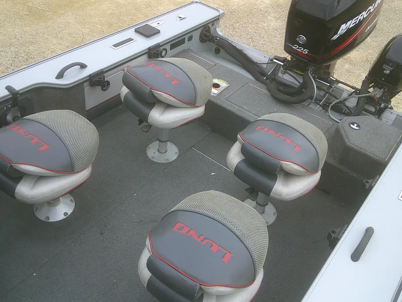 Slide: The Image of 2007 Lund 1900 Pro-V SE boat interior with four seats and a Mercury outboard motor. - 20