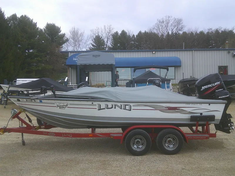 Slide: The Image of 2007 Lund 1900 Pro-V SE boat on trailer, covered, with Mercury outboard motor. - 25