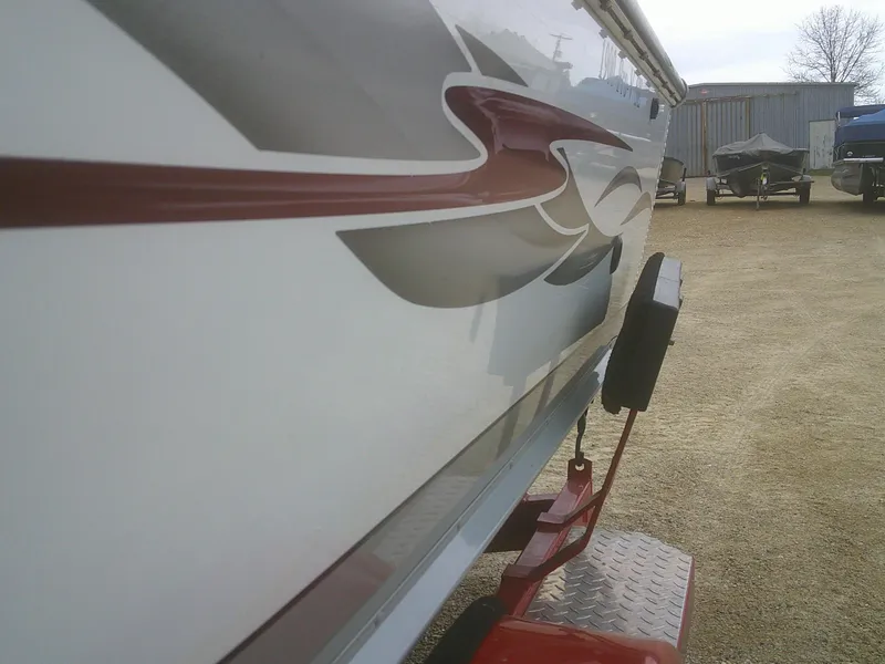 Slide: The Image of 2007 Lund 1900 Pro-V SE boat side view with red and gray graphics. - 6