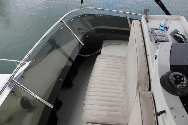 Slide: The Image of 1985 Trojan 10m Fly boat cockpit with seating and navigation equipment. - 10