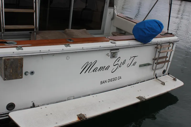 Slide: The Image of 1985 Trojan 10m Fly boat docked, named "Mama Sea Ta," San Diego, CA. - 14