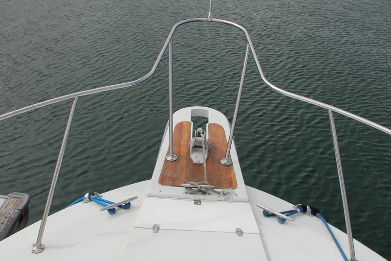 Slide: The Image of Bow view of 1985 Trojan 10m Fly boat with stainless steel railings. - 16