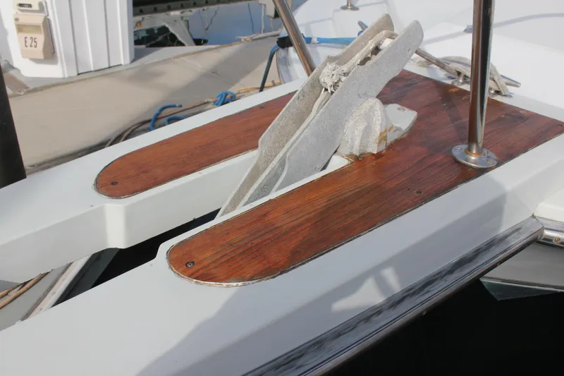 Slide: The Image of 1985 Trojan 10m Fly boat anchor area with wooden accents and metal fittings. - 17