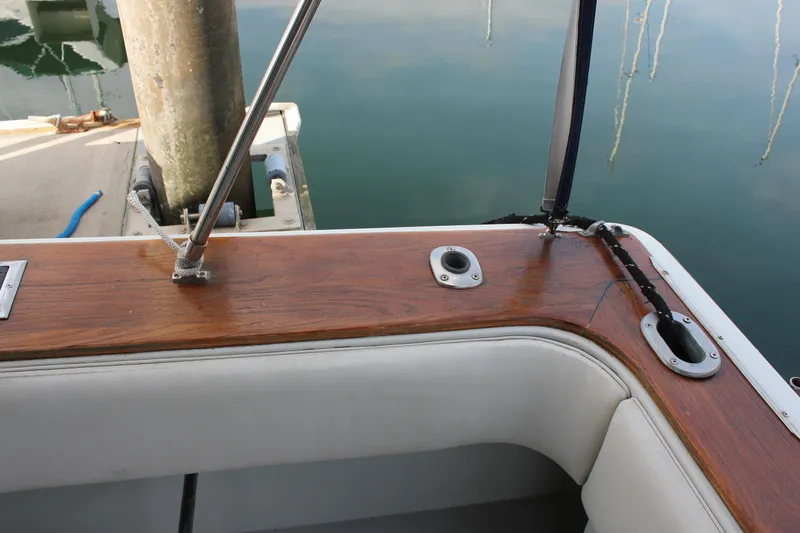 Slide: The Image of 1985 Trojan 10m Fly boat interior with wood trim and white seating. - 20