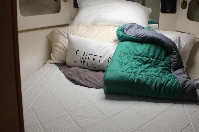 Slide: The Image of Cozy bed in 1985 Trojan 10m Fly yacht with pillows and green blanket. - 25