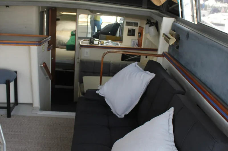 Slide: The Image of Interior of 1985 Trojan 10m Fly yacht with cozy seating and modern decor. - 26