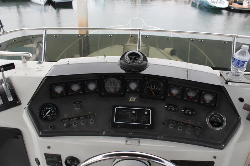 Slide: The Image of Control panel of a 1985 Trojan 10m Fly boat with gauges and steering wheel. - 7