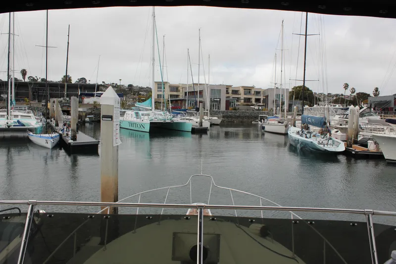 Slide: The Image of View from a 1985 Trojan 10m Fly yacht in a marina with sailboats. - 8