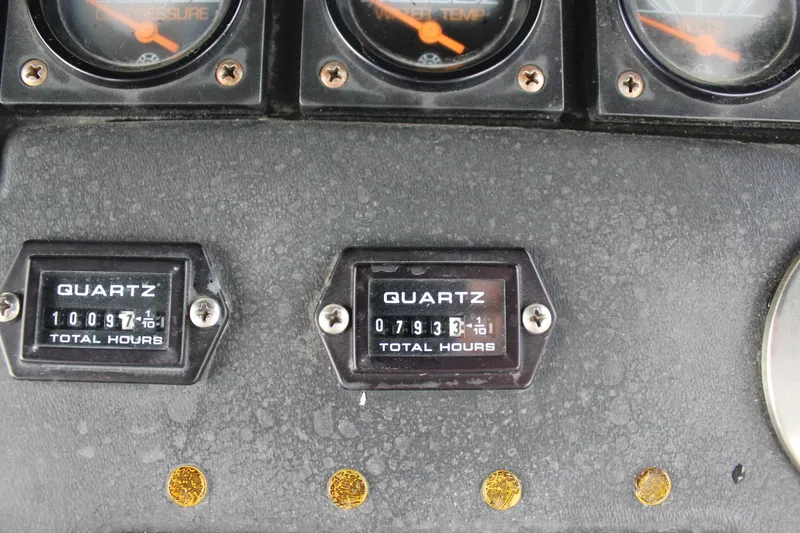 Slide: The Image of Dashboard of a 1985 Trojan 10m Fly boat showing engine hour meters. - 9