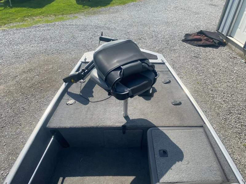 Slide: The Image of 2019 Bass Tracker Classic boat with a swivel seat on a carpeted deck. - 10
